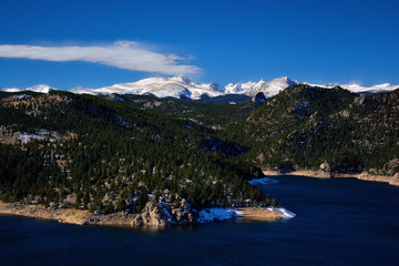 Gross Reservoir in the Colorado Rocky Mountains with Snow Covered Peaks and Pine Trees