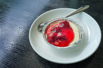 Strawberry Cheese pie on black wooden background