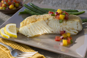 Alaskan Halibut Served on Dinner Plate with Tropical Mango Salsa and Green Beans - obrazy, fototapety, plakaty