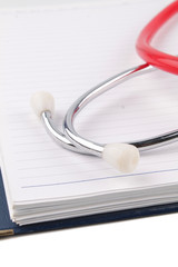 Medical concept. Stethoscope and open notebook on white background