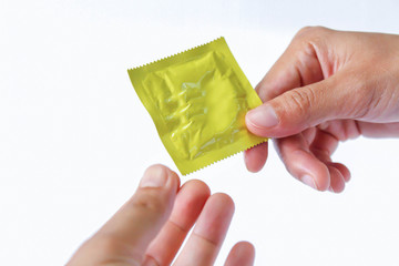 condom in hand isolated on a white background