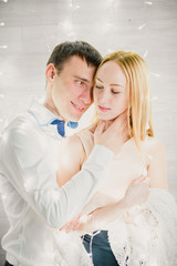 loving couple on a background garlands of lights