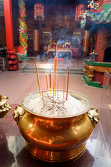 Incense sticks in the pot inside Chinese temple