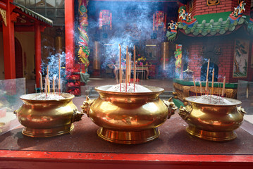 Incense sticks in the pot inside Chinese temple