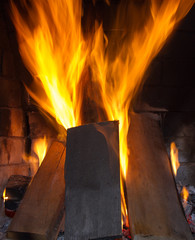 Fototapeta premium Burning firewood in the fireplace close up