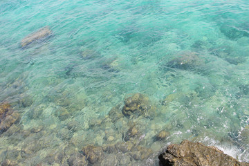 Naklejka na ściany i meble Transparent turquoise sea water, natural background
