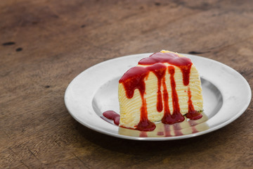 Crap cake on plate with wooden background table