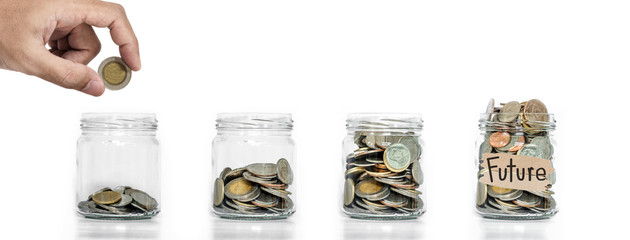 Money saving, Hand putting coin in glass jar with coins inside growing up, on white background,...