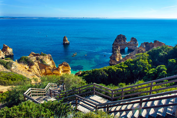 Wooden footbridge walkway to hidden beach Praia do Camilo