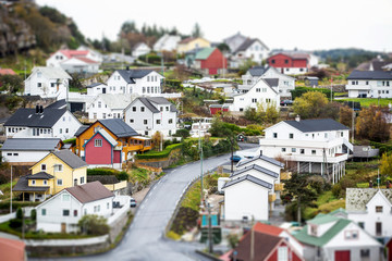 Fototapeta premium Scandinavian village in miniature. Panorama of the town. Small houses, boats. Coast Sea. Tilt shift effect. Europe.