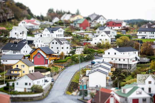 Scandinavian village in miniature. Panorama of the town. Small houses, boats. Coast Sea. Tilt shift effect. Europe.