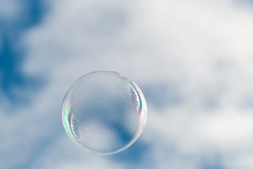 Soap bubble in blue sky