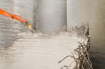 Excavator working at the demolition of an old industrial buildin