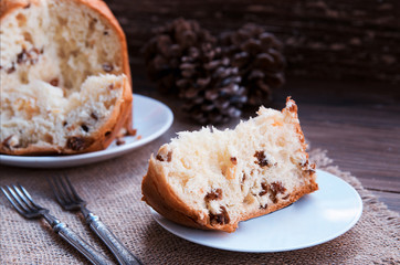 Panettone, Traditional Italian Christmas cake  on rustic background with vintage fork. Copy space.