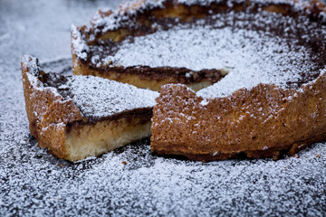 Homemade chocolate tart on black background