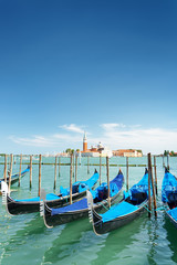 Several gondolas parked beside the Riva degli Schiavoni, Venice