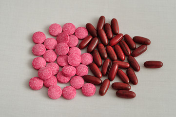 Brown capsules and pink tablets