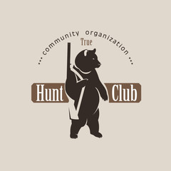 Obraz premium Logo bear with a gun. Vector logo of a hunting club.