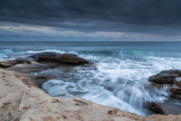 Waves crashing on the rocky beach