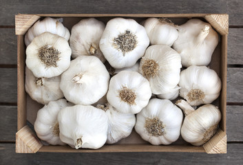 Wooden box of fresh garlic