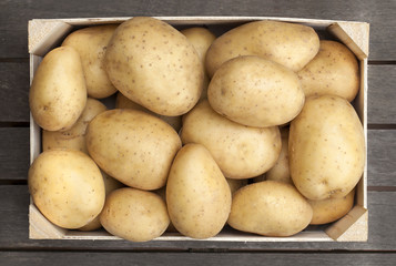 Wooden box of fresh potatoes