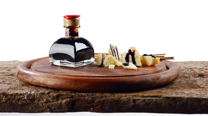 Obraz na płótnie Canvas Balsamic vinegar end Parmiggiano Reggiano with white in the background
