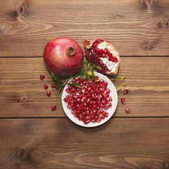 Still life with pomegranate on wooden background