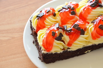 chocolate cake topping cream and dressing strawberry sauce on dish