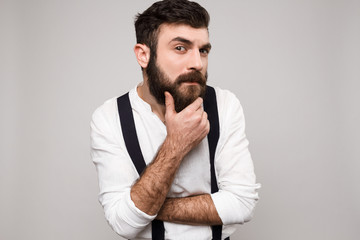 Young handsome man posing over white background.