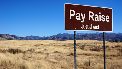 Pay Raise brown road sign