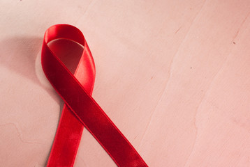red ribbon on the wooden background