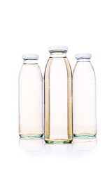 Translucent liquid in glass bottle on white background