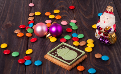 xmas cookie with colored candies on wooden background
