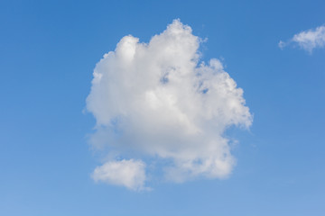 Cumulus clouds over the blue sky background.