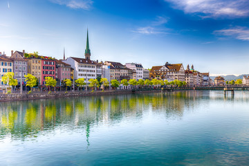 Beautiful view of the historic city center of Zürich with famous Fraumünster Church and swans on river Limmat on a sunny day with blue sky, Canton of Zürich, Switzerland. - obrazy, fototapety, plakaty