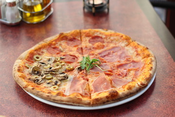 Restaurant food with fresh ingredients - salami pizza