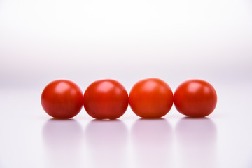 Fresh cherry tomatoes line isolated on white background cutout