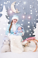 Snow Maiden a baby in Christmas decorations