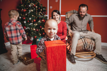 Christmas family portrait in home holiday living room, kids and baby with parents, decorating house...