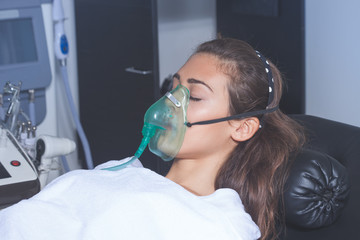 young woman with oxygen mask
