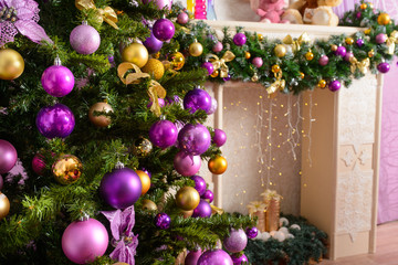 Christmas tree decorated in purple toy. background with gifts