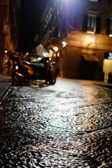 Wet street at night in Florence, Italy.