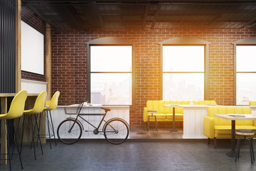 Cafe interior with brick walls and a bicycle, toned