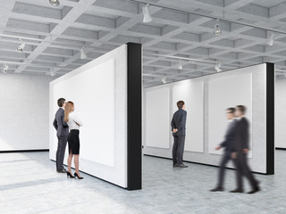 Fototapeta premium People looking at pictures in art gallery with interesting ceili