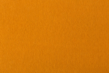 Bright orange felt background close-up.