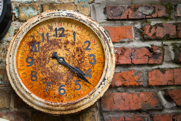 Old Rusty Clock attached onto the wall