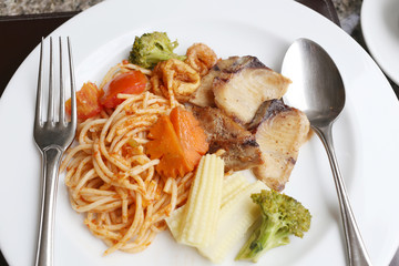 Fried Spaghetti and grilled fish on white dish.