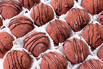 Homemade chocolate truffles on white background.