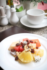 Fruit salad on white dish.