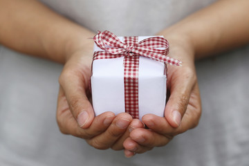 White Gift box on women hands.